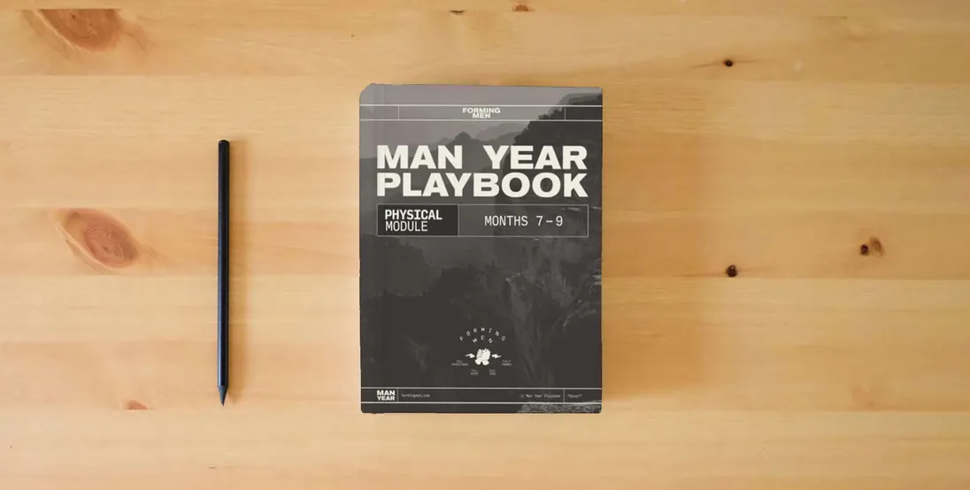 The book Man Year Playbook: Physical Module} is on the table