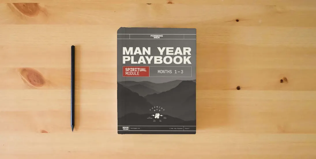 The book Man Year Playbook: Spiritual Module} is on the table