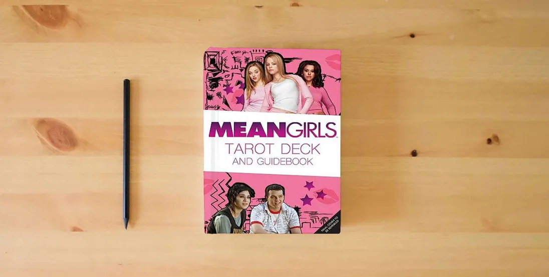The book Mean Girls Tarot Deck and Guidebook} is on the table