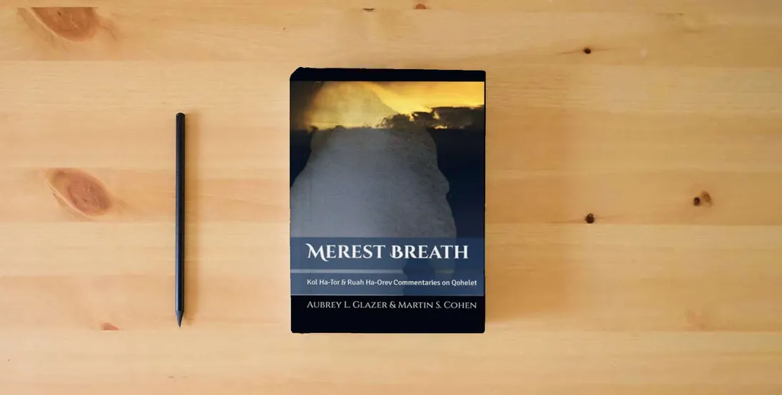 The book Merest Breath: Qohelet Translation and Commentaries} is on the table