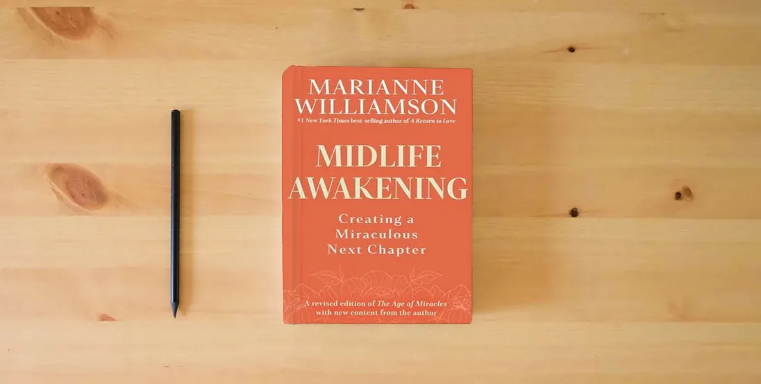 The book Midlife Awakening: Creating a Miraculous Next Chapter} is on the table