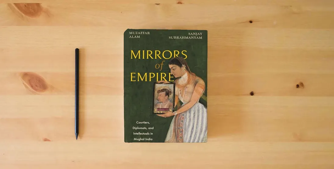 The book Mirrors of Empire: Courtiers, Diplomats, and Intellectuals in Mughal India} is on the table