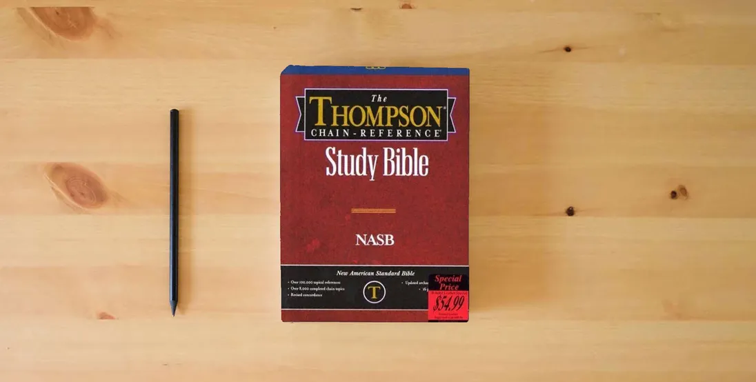The book NASB - Black Bonded Leather - Regular Size - Thompson Chain Reference Bible (016090)} is on the table