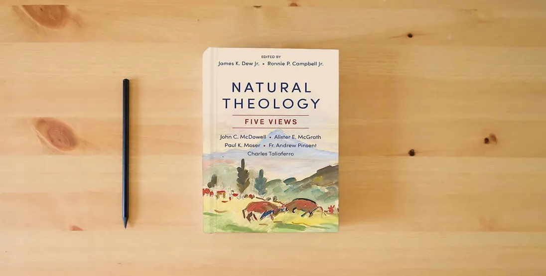 The book Natural Theology: Five Views} is on the table
