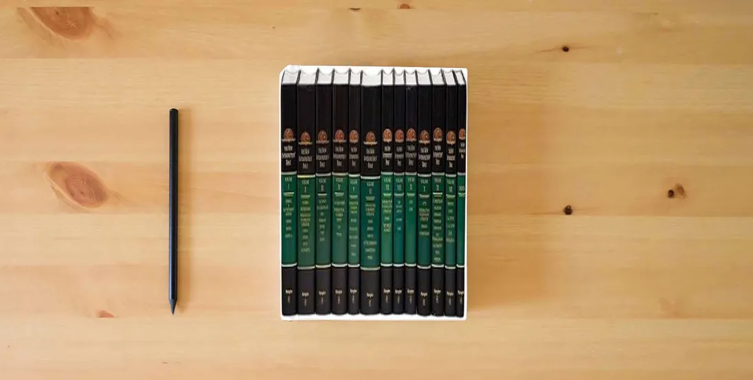 The book New Interpreter's Bible (12 Volume Set + Index)} is on the table