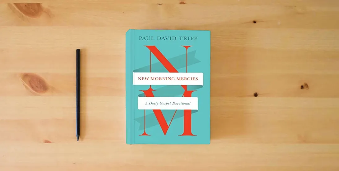 The book New Morning Mercies: A Daily Gospel Devotional} is on the table