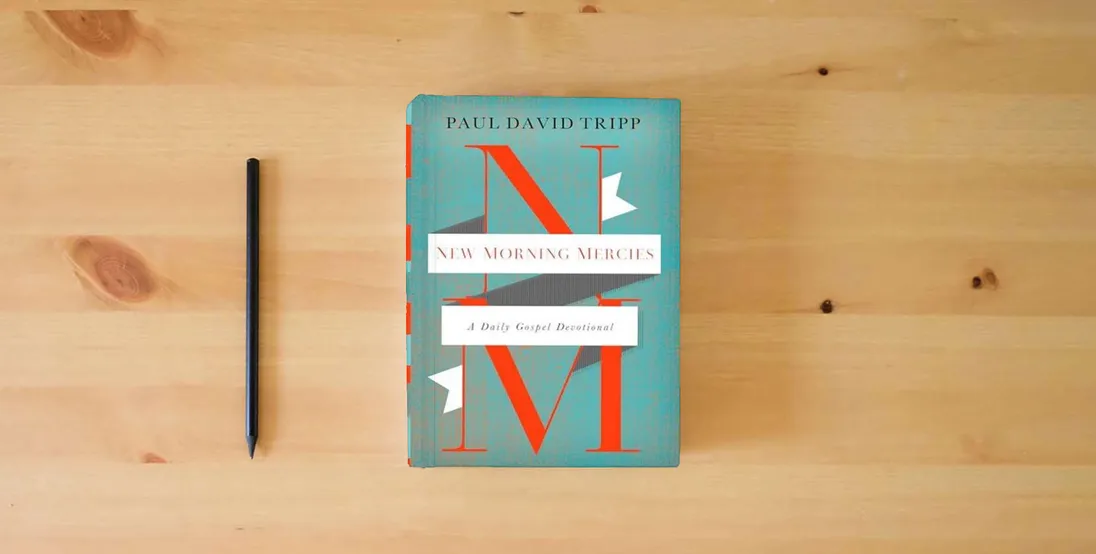 The book New Morning Mercies: A Daily Gospel Devotional} is on the table