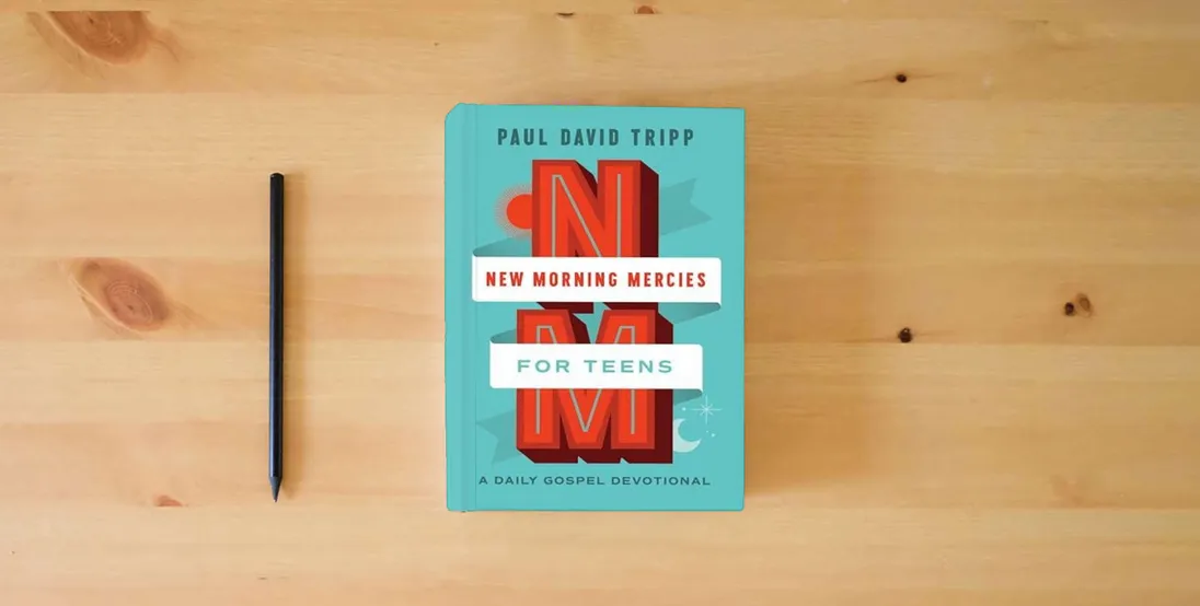 The book New Morning Mercies for Teens: A Daily Gospel Devotional} is on the table