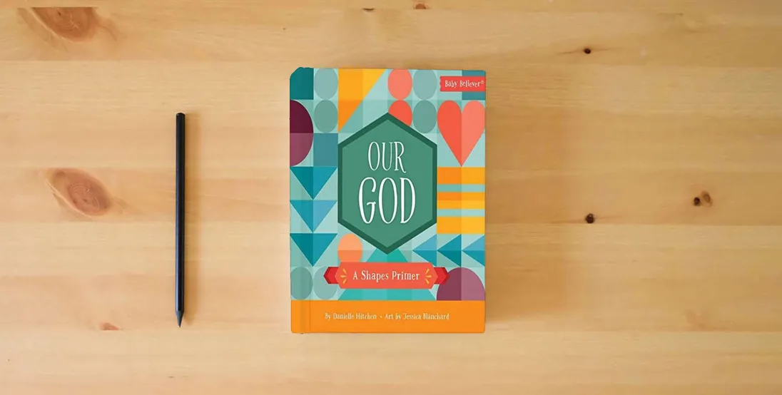 The book Our God: A Shapes Primer (Baby Believer)} is on the table