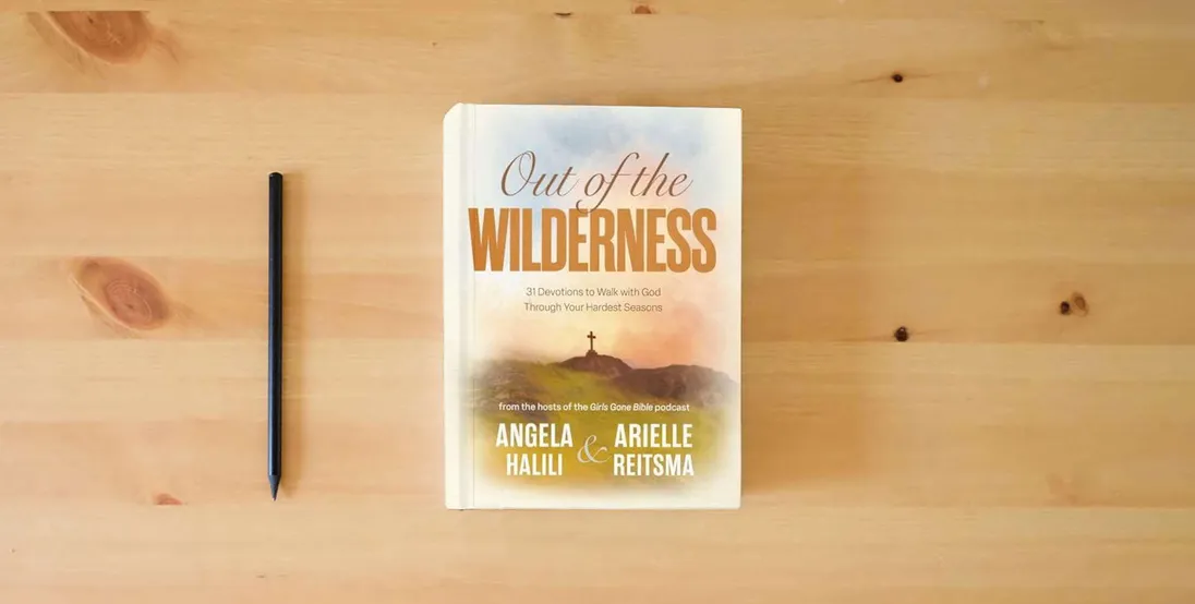 The book Out of the Wilderness: 31 Devotions to Walk with God Through Your Hardest Seasons: A Devotional} is on the table