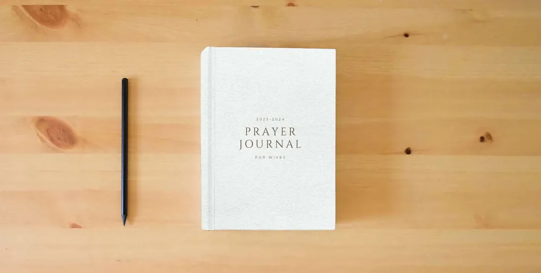 The book Prayer Journal for WIVES} is on the table