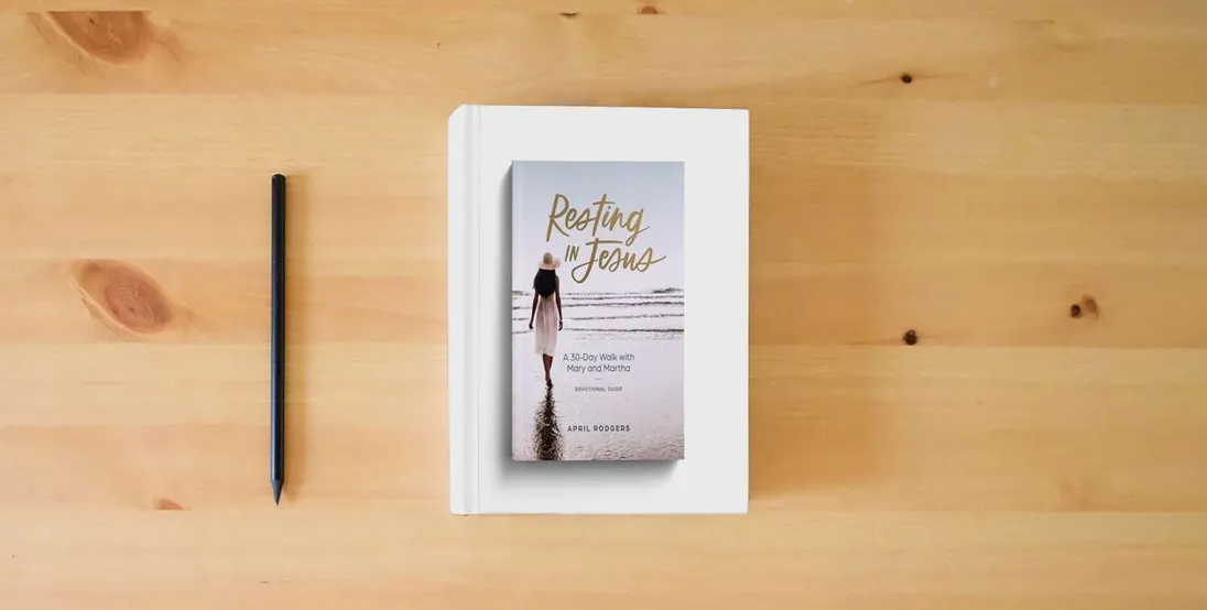 The book Resting in Jesus: A 30 Day Walk with Mary & Martha Devotional} is on the table