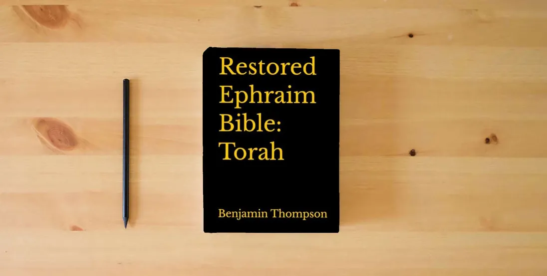 The book Restored Ephraim Bible: Torah} is on the table