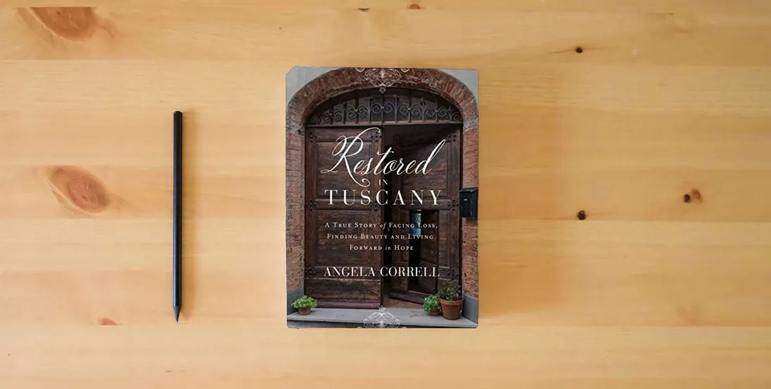 The book Restored in Tuscany: A True Story of Facing Loss, Finding Beauty, and Living Forward in Hope} is on the table
