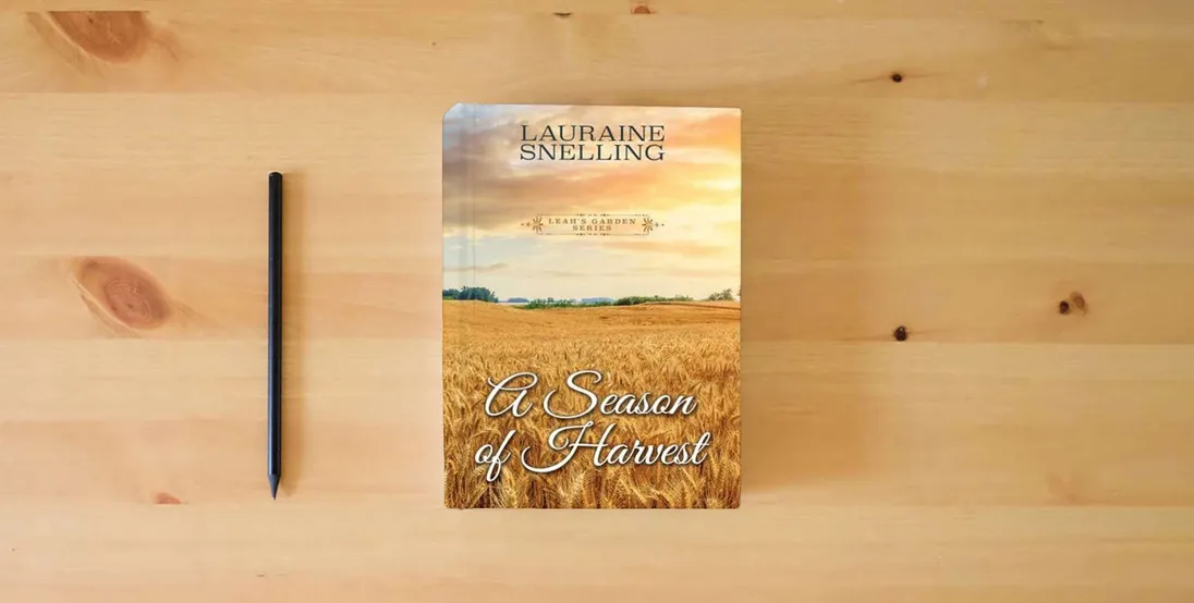 The book A Season of Harvest (Leah's Garden, 4)} is on the table