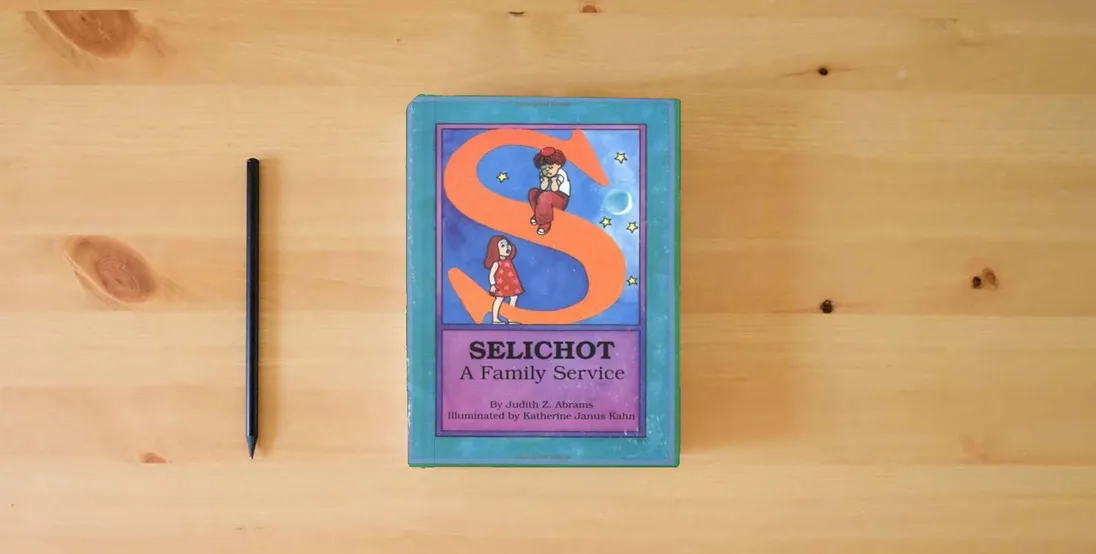 The book Selichot--A Family Service} is on the table