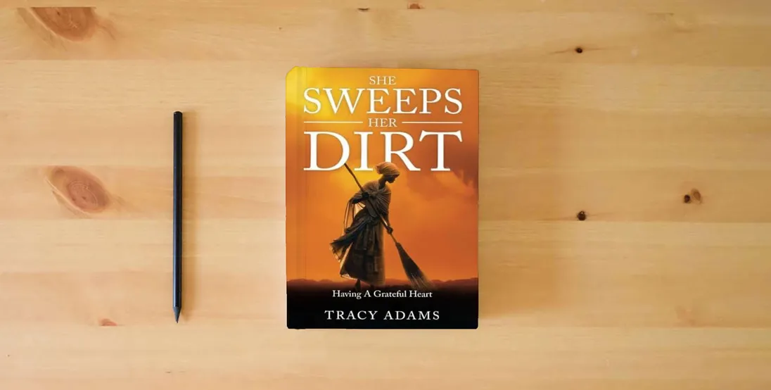 The book She Sweeps Her Dirt: Having A Grateful Heart} is on the table