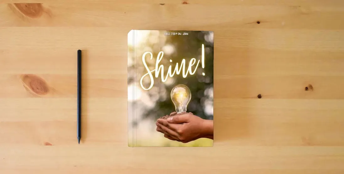 The book Shine! Bible Study on 1 John (Teacher Bible Studies)} is on the table