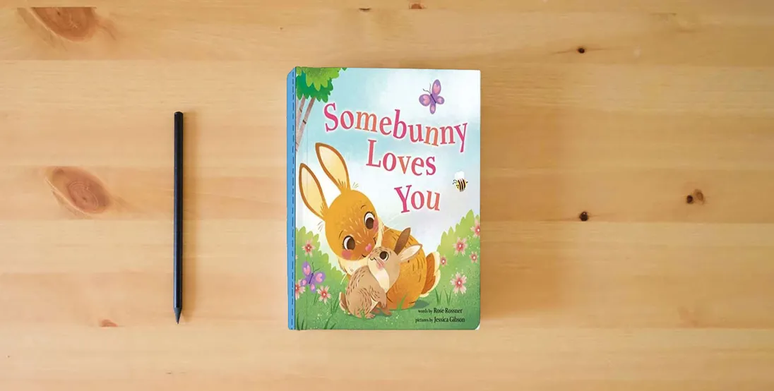 The book Somebunny Loves You: A Sweet and Silly Easter Board Book for Babies and Toddlers (Punderland)} is on the table