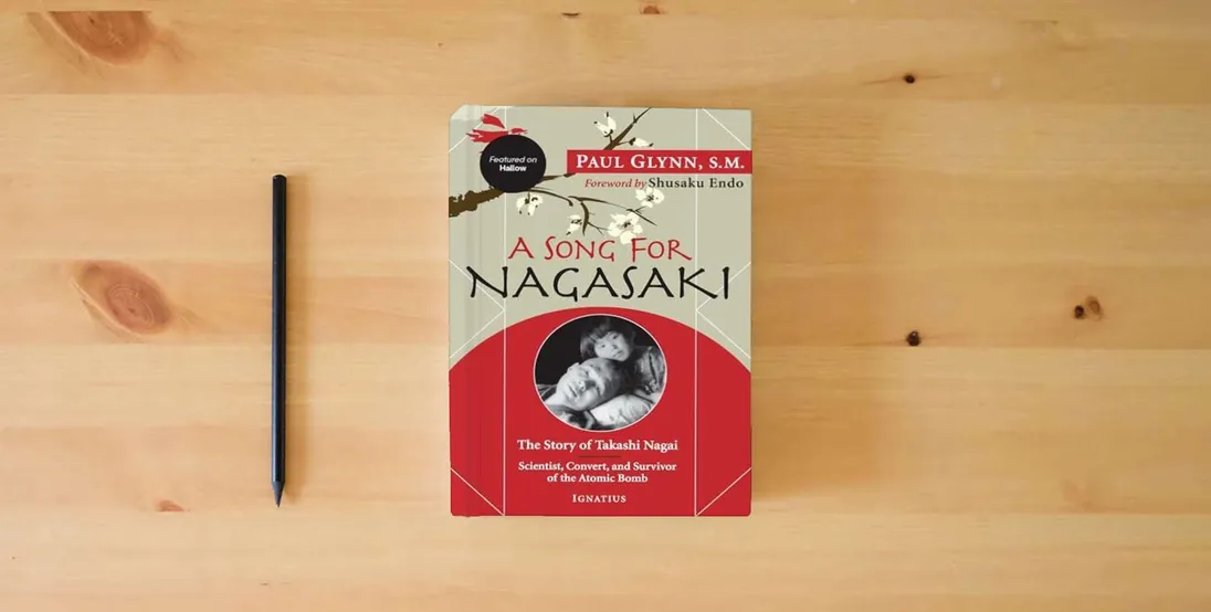 The book A Song for Nagasaki - Hallow Edition: The Story of Takashi Nagai a Scientist, Convert, and Survivor of the Atomic Bomb} is on the table