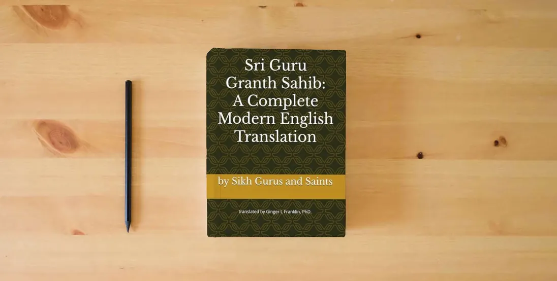 The book Sri Guru Granth Sahib: A Complete Modern English Translation} is on the table
