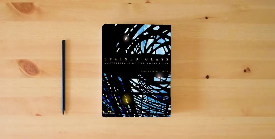 The book Stained Glass: Masterpieces of the Modern Era} is on the table