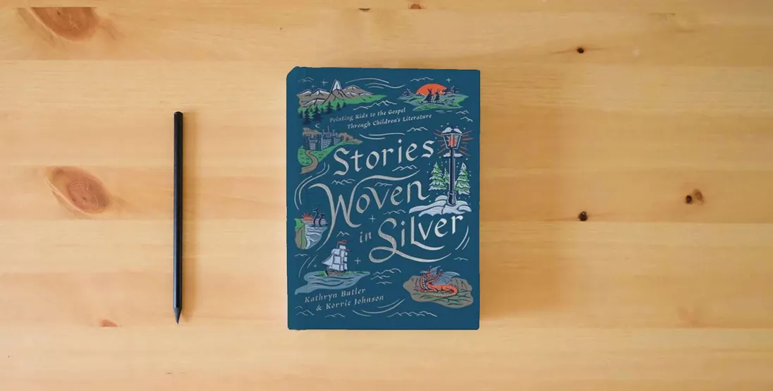 The book Stories Woven in Silver: Pointing Kids to the Gospel Through Children's Literature} is on the table