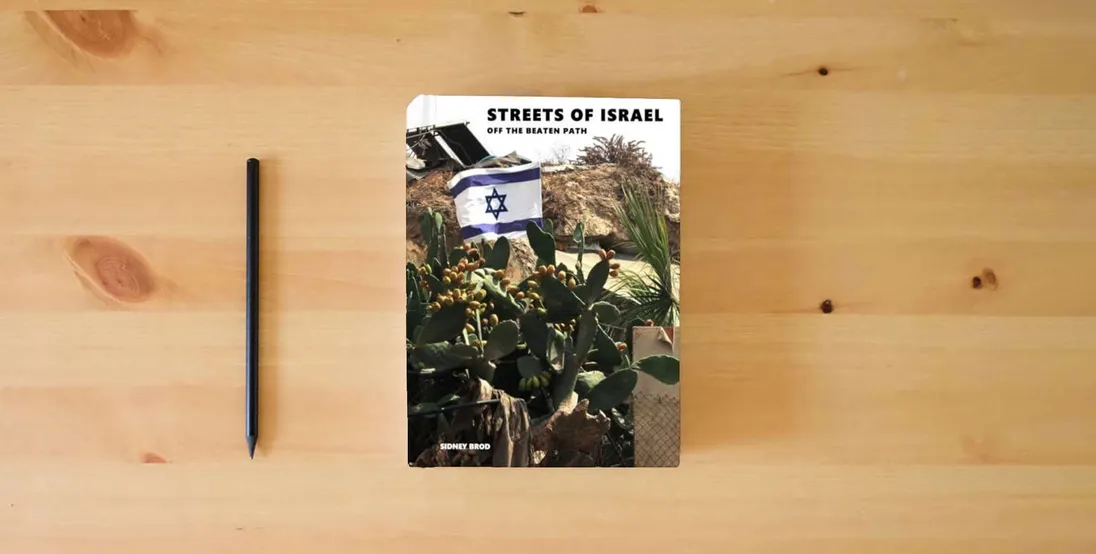 The book Streets of Israel: Off The Beaten Path - Coffee Table Photo Collection} is on the table