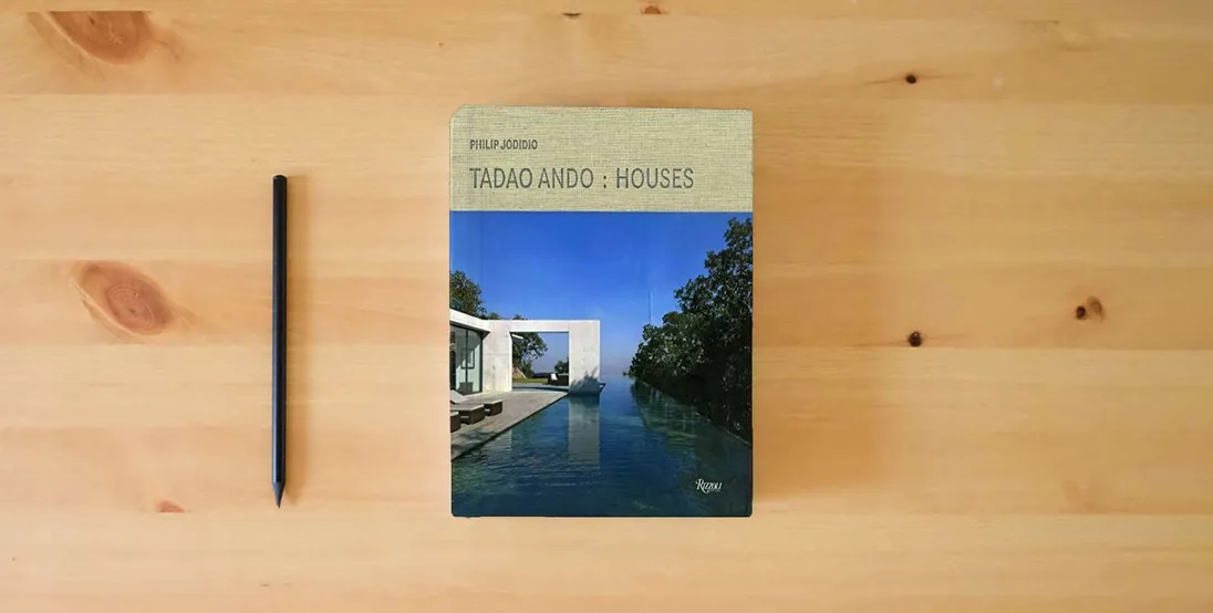 The book Tadao Ando: Houses} is on the table
