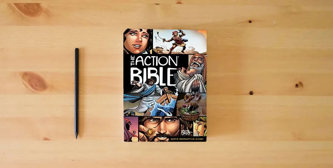 The book The Action Bible: God's Redemptive Story (Action Bible Series)} is on the table