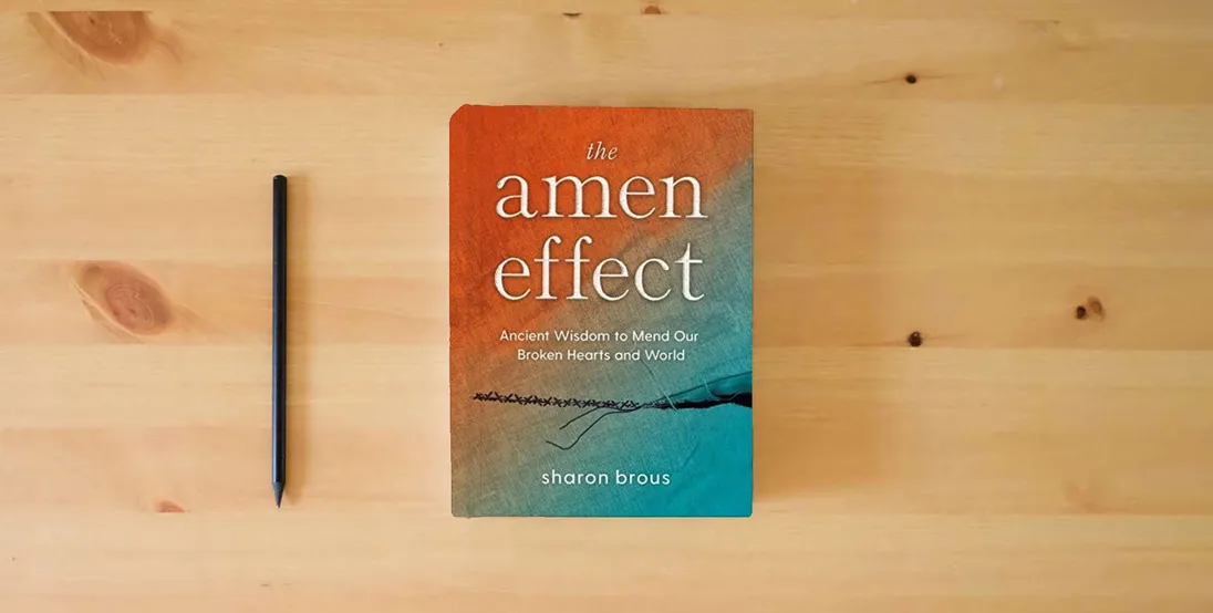 The book The Amen Effect: Ancient Wisdom to Mend Our Broken Hearts and World} is on the table