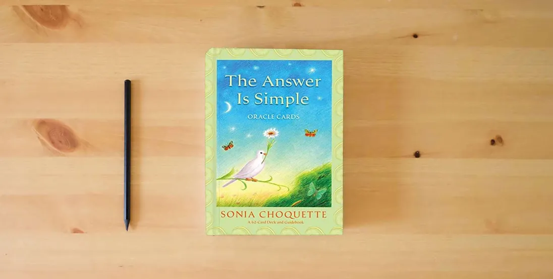The book The Answer is Simple Oracle Cards} is on the table