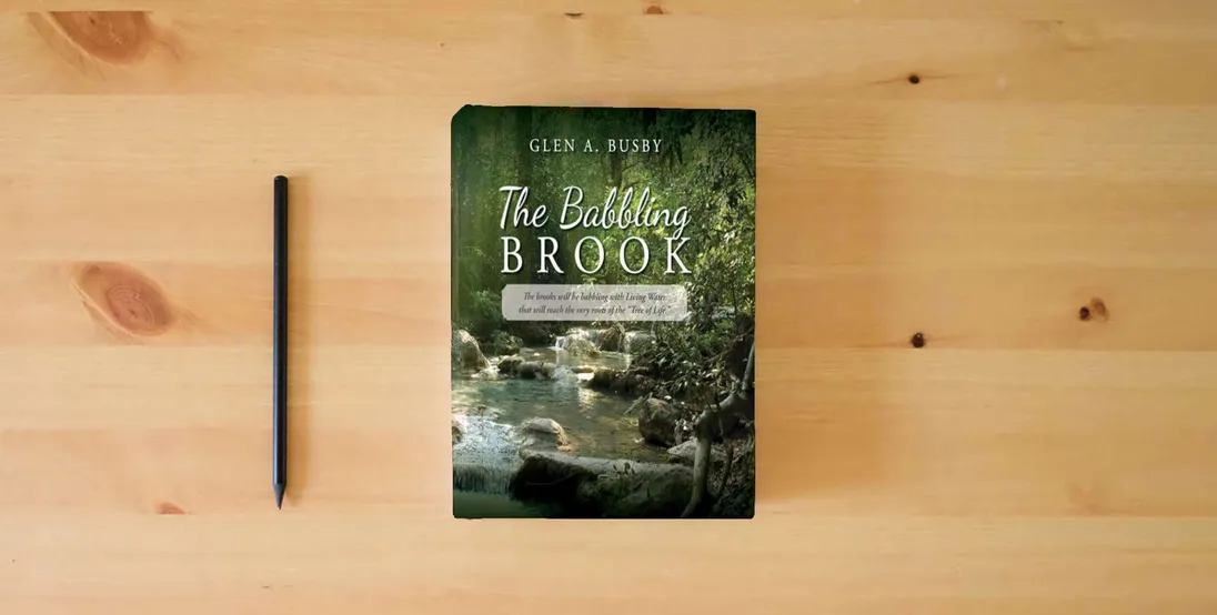 The book The Babbling Brook: The brooks will be babbling with Living Water that will reach the very roots of the "Tree of Life."} is on the table