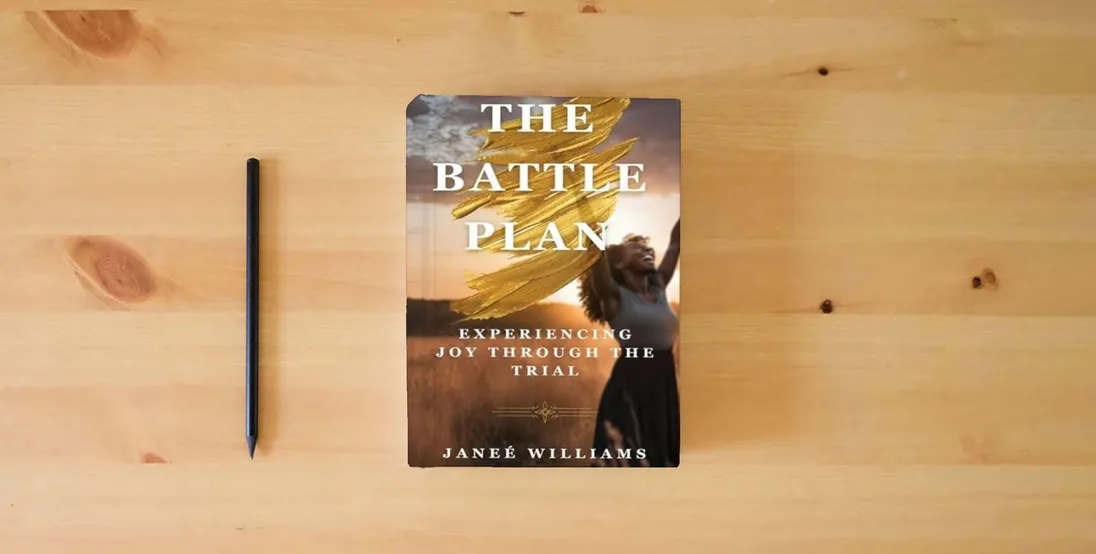 The book The Battle Plan: Experiencing Joy Through the Trial} is on the table