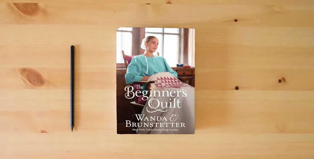 The book The Beginner's Quilt} is on the table