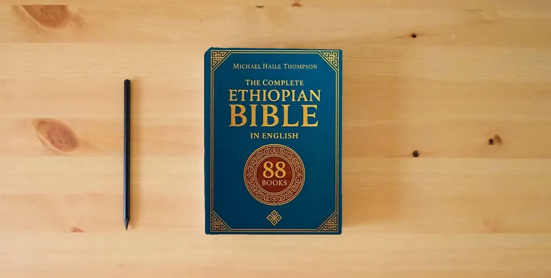 The book The Complete ETHIOPIAN BIBLE in English: Groundbreaking Translation and Critical Commentary Including Apocrypha, Enoch, Jubilees, and Other Rare Texts} is on the table