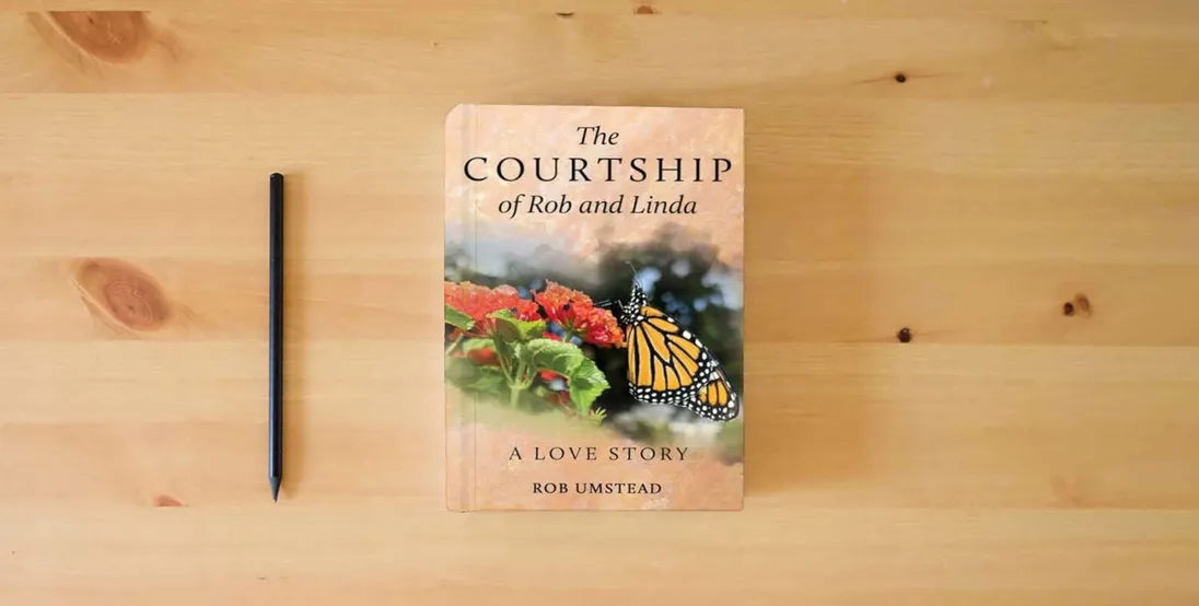 The book The Courtship of Rob and Linda: A Love Story} is on the table