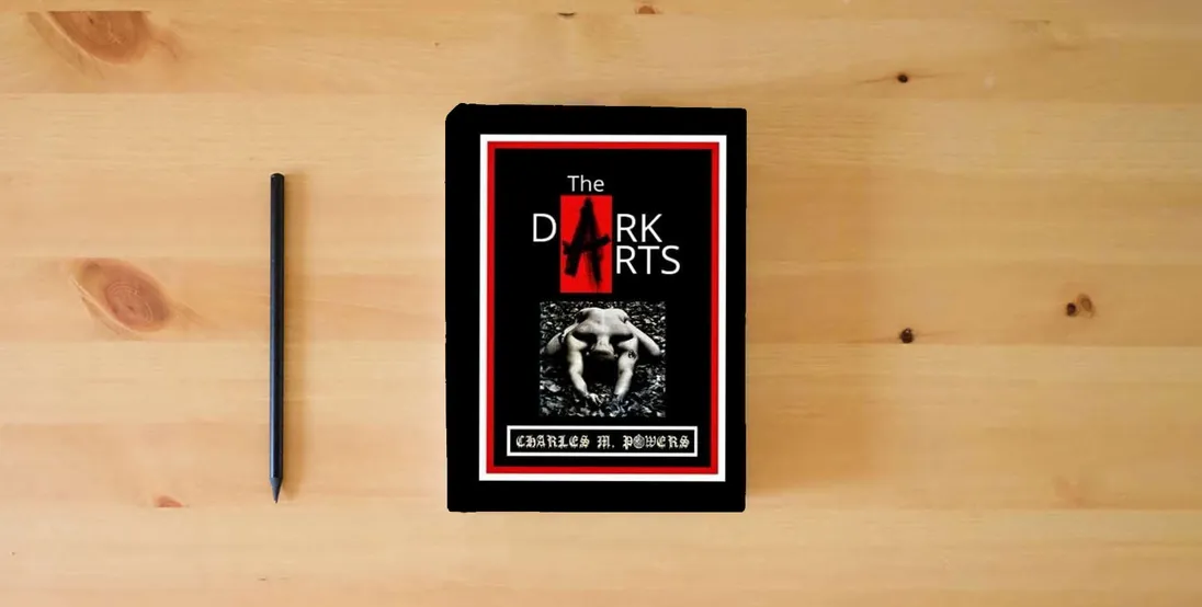 The book The DARK ARTS} is on the table