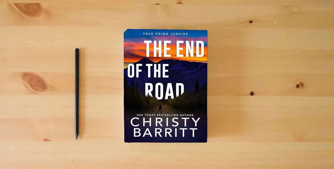 The book The End of the Road (True Crime Junkies)} is on the table