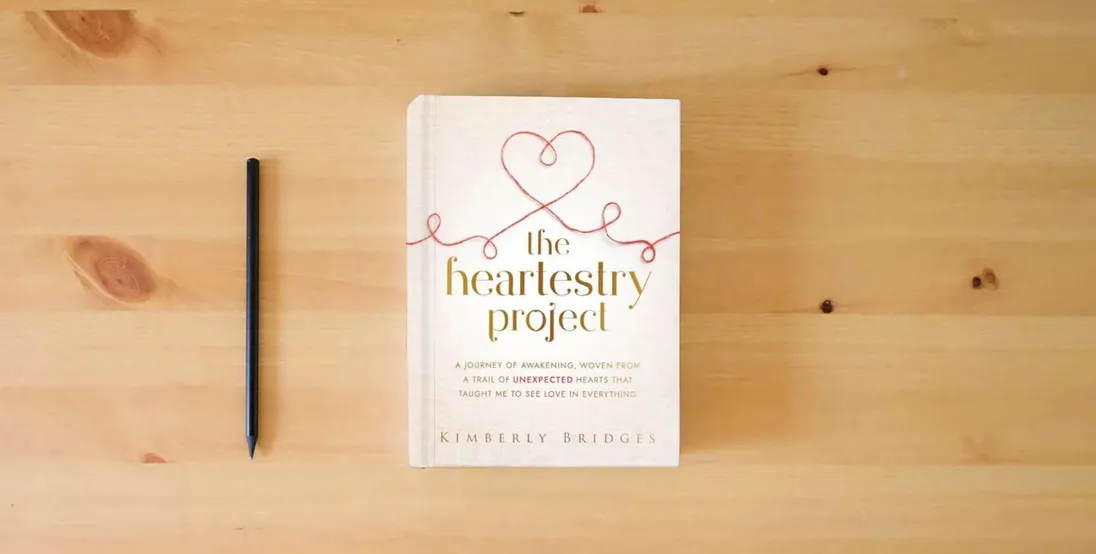 The book The Heartestry Project: A Journey of Awakening, Woven From a Trail of Unexpected Hearts That Taught Me to See Love in Everything} is on the table