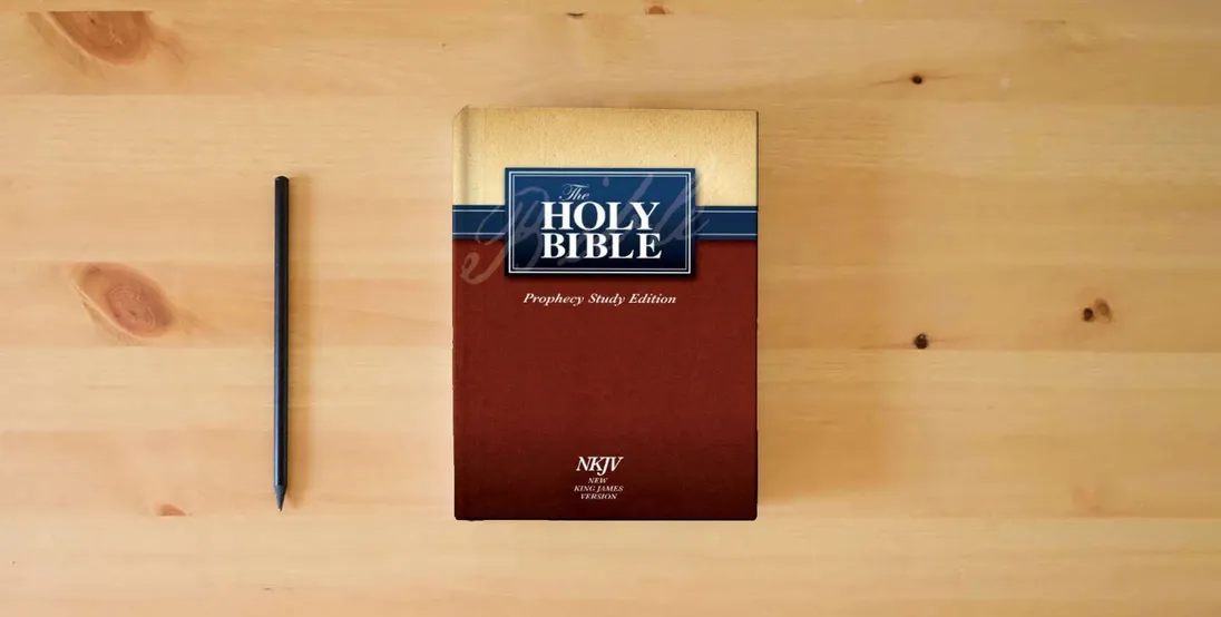 The book The Holy Bible Prophecy Study Edition: NKJV} is on the table