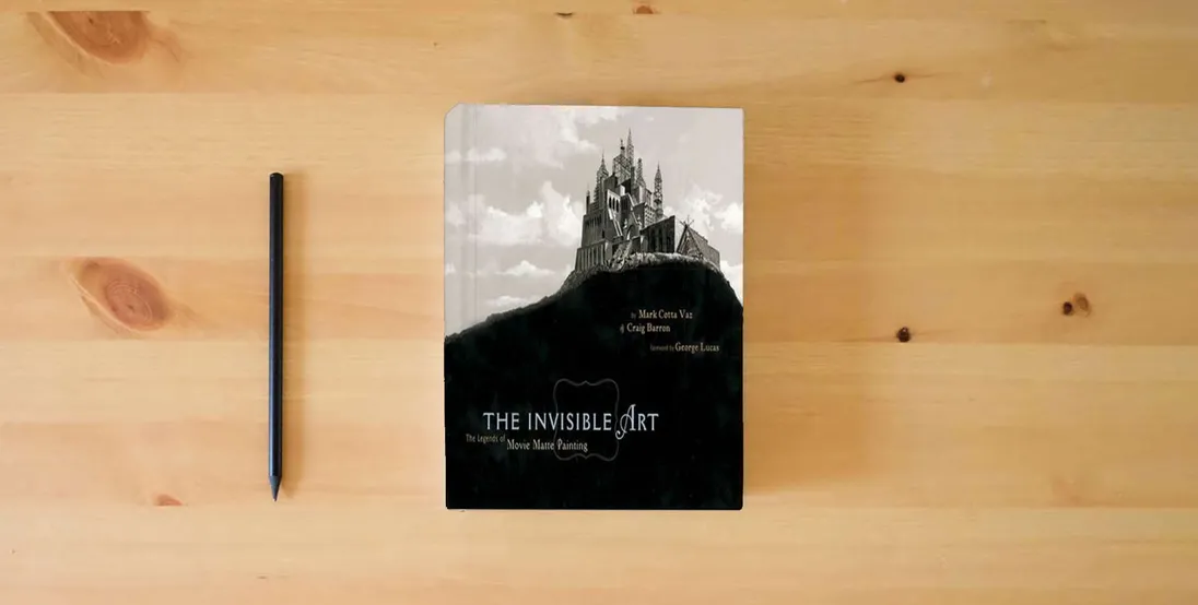 The book The Invisible Art: The Legends of Movie Matte Painting} is on the table