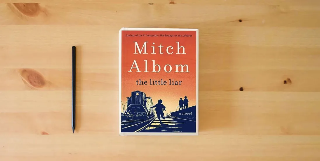 The book The Little Liar: A Novel} is on the table