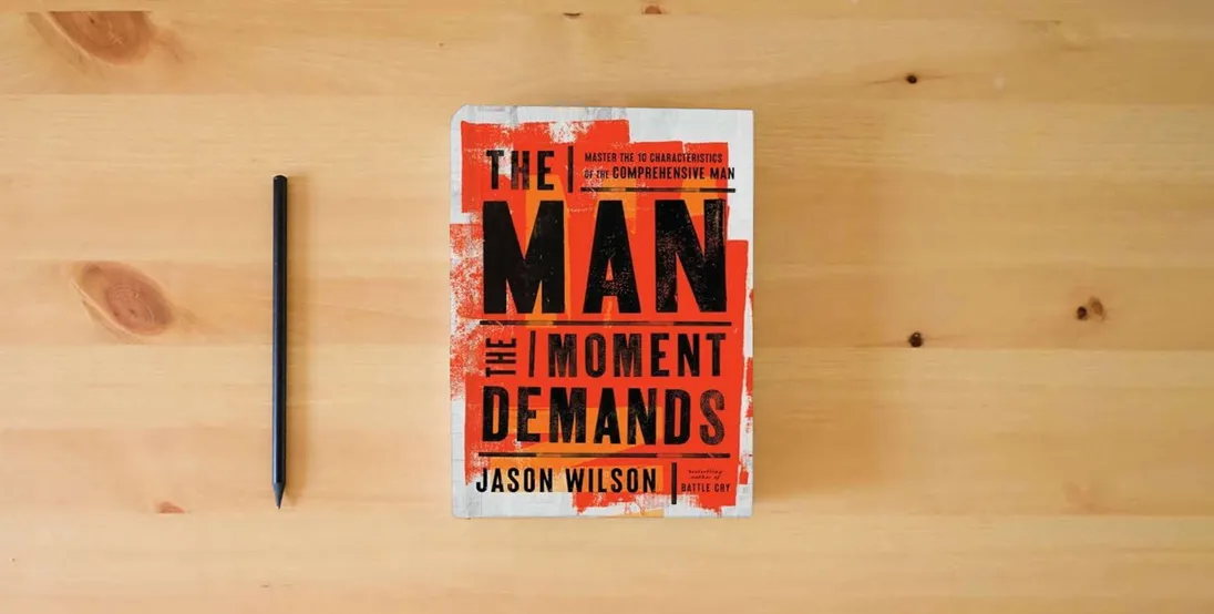 The book The Man the Moment Demands: Master the 10 Characteristics of the Comprehensive Man} is on the table