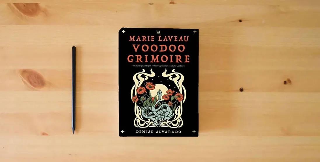 The book The Marie Laveau Voodoo Grimoire: Rituals, Recipes, and Spells for Healing, Protection, Beauty, Love, and More} is on the table
