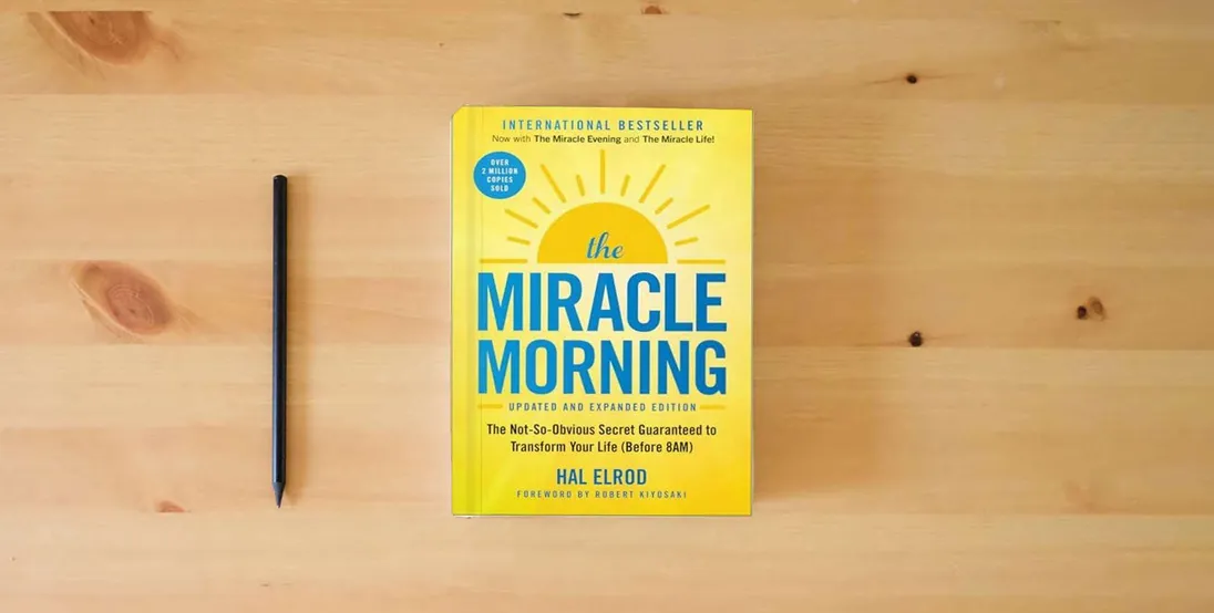 The book The Miracle Morning (Updated and Expanded Edition): The Not-So-Obvious Secret Guaranteed to Transform Your Life (Before 8AM) (Miracle Morning Book Series)} is on the table