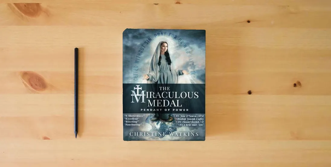 The book The Miraculous Medal: Pendant of Power} is on the table
