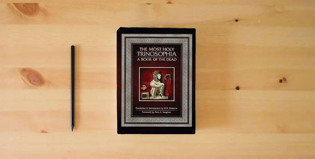 The book The Most Holy Trinosophia: A Book of the Dead} is on the table