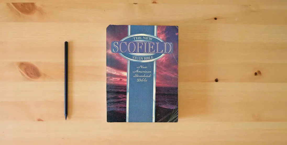 The book The New Scofield Study Bible: New American Standard Bible} is on the table