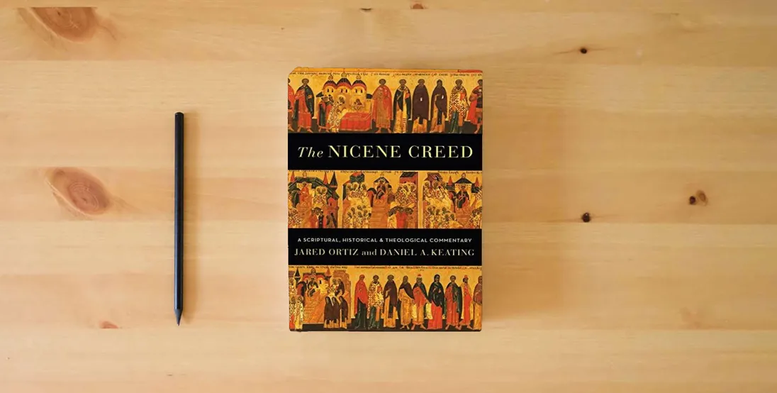 The book The Nicene Creed: A Scriptural, Historical, and Theological Commentary} is on the table
